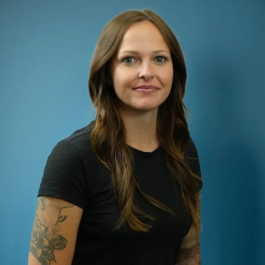 Professional headshot of a Driver Advantage team member wearing a black shirt against a blue background, representing the company’s friendly and professional staff